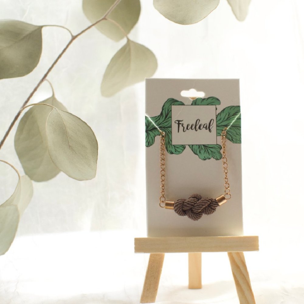 Gold Rust Be Bold Taupe Tie Knot Necklace: Reminder of Courage and Strength